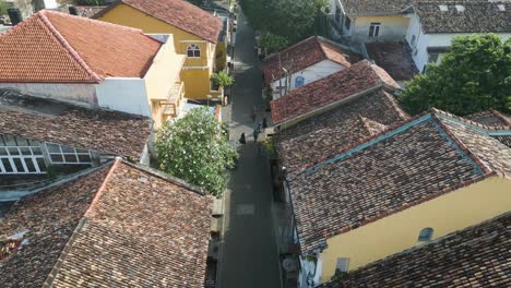 Low-aerial-shot-over-a-street-in-a-residential-area-of-houses-in-the-old-town-of-Galle-in-Sri-Lanka