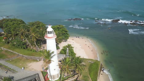 Aerial-circular-shot-over-the-white-lighthouse-of-Galle-Dutch-Fort