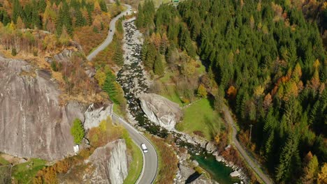 Aerial-View-Of-Cars-Driving-On-Mountain-Pass-In-Val-di-Mello-During-Autumn-In-Lombardy,-Italy