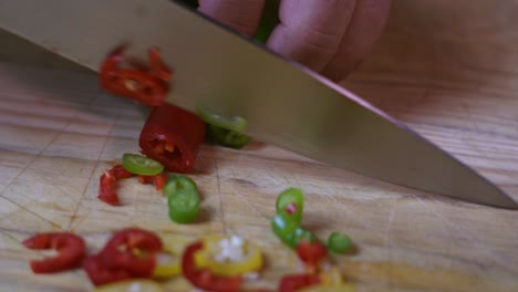 Cook-red-pepper-and-green-pepper-chilli-on-wooden-chopping-board