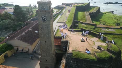 Aerial-drone-shot-around-Galle-Forts-Clock-Tower,-Sri-Lanka