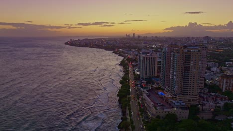 Seafront-skyscrapers-along-Malecon-at-sunset,-Santo-Domingo-in-Dominican-Republic