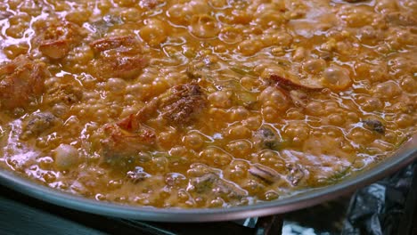 Close-up-of-a-paella-with-boiling-rice