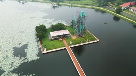 Aerial-circular-view-on-artificial-Wiluwa-lake-with-a-statue-on-it