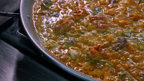 Paella-rice-cooking-in-paella-pan