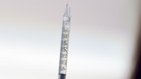 Pushing-the-air-out-of-a-syringe-of-medication---macro