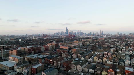 Aerial-view-of-the-Bridgeport-neighborhood-and-the-Stevenson-Expressway,-winter-sunrise-in-Chicago,-USA---ascending,-drone-shot