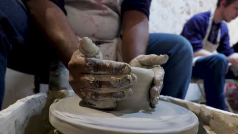 overhead-close-view-of-an-African-American-hands-spinning-clay-very-sporadically
