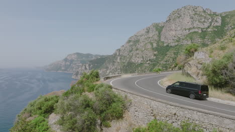 Fast-aerial-footage-following-a-passenger-van-as-they-drive-on-the-Amalfi-Coast-road