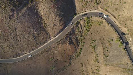 Cars-are-driving-along-the-tiny-Los-Ajaches-road,-Lanzarote,-Canary-Island