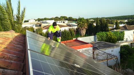Un-Experto-Instalando-Paneles-Solares-Sobre-Un-Techo-De-Ladrillo-En-El-Pueblo-En-Un-Día-Soleado-Con-Viento