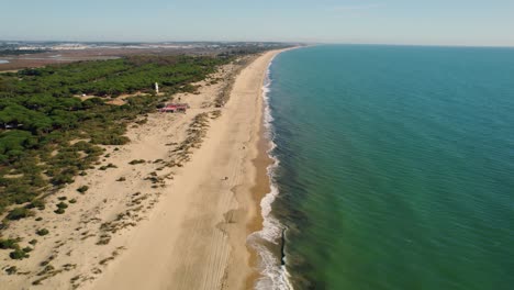 Drone-Video-Descending-Over-Huelva-Beach-a-popular-Spanish-tourist-destination,-in-the-Daytime