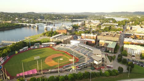 Chattanooga-township-with-majestic-baseball-stadium-on-sunny-evening,-aerial-orbit-view