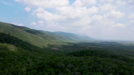 Mexico-Hyperlapse-tropical-landscape-green-jungle-hills-sloping-to-fluvial-valley-with-cumulus-clouds-forming-overhead-steady-pace-fast-moving-onshore-breeze-wind-lush