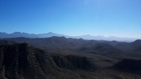 Pan-into-the-Desert-Mountains-in-Baja-Mexico-Sierra-de-la-Laguna-Mountain-Range-while-Off-roading-with-a-Jeep