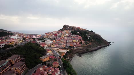 Aerial-panorama-of-colored-italian-town-Castelsardo-on-seaside-coast,-Sardinia