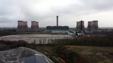 Aerial-reversing-view-across-coal-fired-power-station-site,-Fiddlers-Ferry-overcast-smokestack-skyline