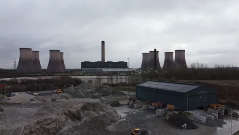 Aerial-dolly-view-across-coal-fired-power-station-site,-Fiddlers-Ferry-smokestack-overcast-skyline