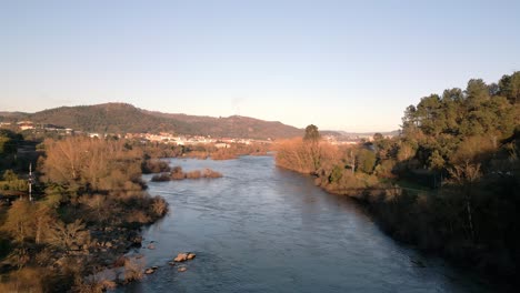 Aerial-shot-over-River-Miño-in-Spain,-great-vegetation,-horizon-and-blue-sky