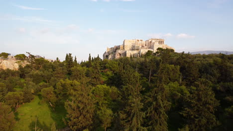 Athens,-Greece,-Acropolis-EPIC-Reveal,-Thru-Trees,-Rising-UP,-Parthenon,-Ancient-Greece,-Mars-Hill,-Apostle-Paul,-Disciples,-Warm-Sunset,-Cruise-Ship-Destination,-Hotels,-Travel-Ad,-Greenery