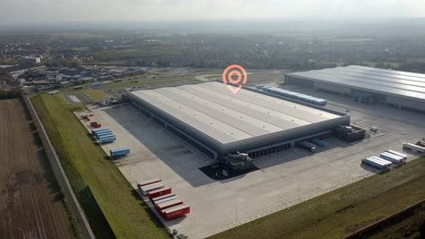 Aerial-view-orbiting-distribution-warehouse-with-GPS-location-pin-graphic-overlay
