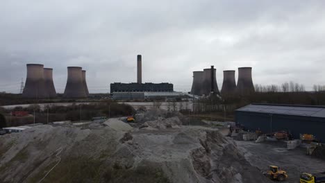 Aerial-view-passing-across-coal-fired-power-station-site,-Fiddlers-Ferry-smokestack-overcast-skyline