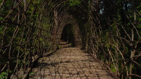 Shot-through-a-passage-made-of-tree-branches,-artistic-construction-Ponte-di-S