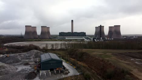Aerial-descending-view-across-coal-fired-power-station-site,-Fiddlers-Ferry-overcast-smokestack-skyline