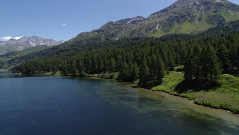 Aerial-Dolly-Left-View-Over-Lake-Silvaplana-Shoreline-With-Mountain-Views-In-Background