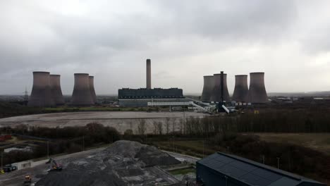 Aerial-orbiting-view-across-coal-fired-power-station-site,-Fiddlers-Ferry-overcast-smokestack-skyline