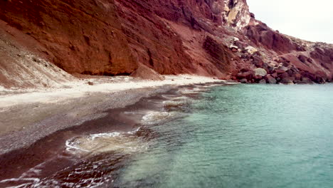 Red-Sand-Beach,-Red-Volcanic-Sand,-Santorini-Greece,-Tourist-Destination,-Off-Season-Empty-Beach,-Blue-Waters,-Teal-and-Orange