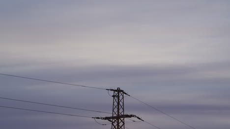 Medium-shot-of-an-electricity-pylon-at-sunrise