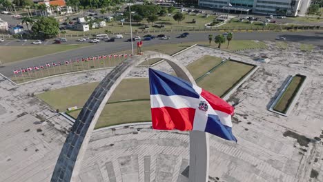 Aerial-View-Of-Flag-Square-of-Santo-Domingo-In-The-Dominican-Republic-Overlooking-Daytime-Traffic-On-The-Road