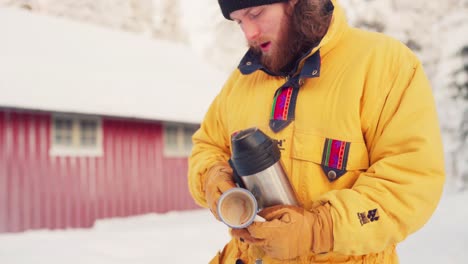 Caucasian-Guy-Is-Pouring-Hot-Water-To-A-Mug-During-Winter