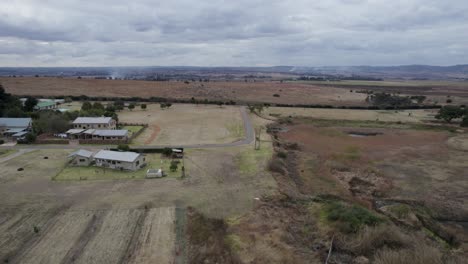 Rural-farmlands-community---aerial-track-Buildings-and-solar-panels