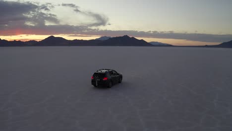 SUV-races-across-open-salt-flat-desert-in-Utah