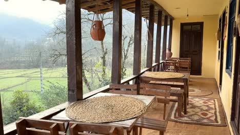 Local-House-Cottage-Hut-wooden-cabin-lodge-in-the-forest-in-orange-yellow-autumn-fall-scenic-winter-view-of-balcony-terrace-rice-field-paddy-sit-on-wood-dining-table-traditional-food-art-carpet-Iran