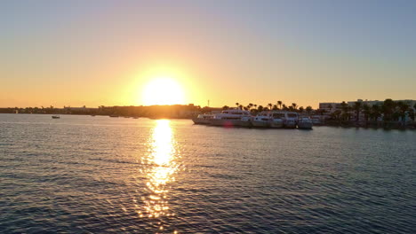Bright-Sun-Durign-Sunset-Reflecting-In-The-Calm-Sea-Near-The-Marina
