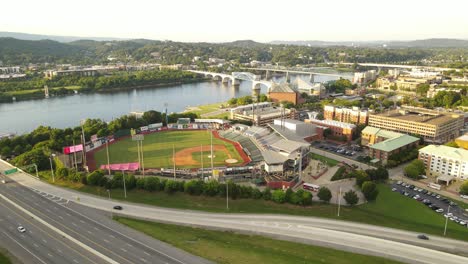 American-township-with-baseball-stadium-and-river,-aerial-drone-view