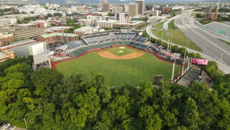 Chattanooga-cityscape-with-baseball-stadium-and-interstate-highway,-aerial-view