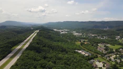 TN-29-highway-and-local-small-town-of-private-homes,-aerial-view