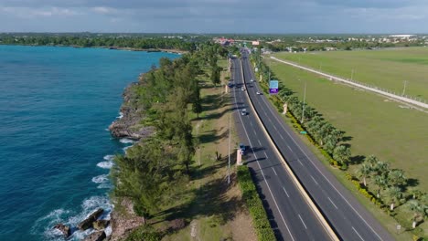 Aerial-View-Of-Cars-Driving-In-The-Road-Near-The-Las-Americas-International-Airport-In-La-Caleta,-Boca-Chica,-Santo-Domingo,-Dominican-Republic