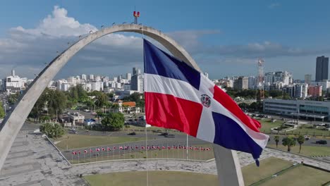 Close-up-shot-of-waving-Flag-of-Dominican-Republic-in-front-of-Skyline-in-Santo-Domingo