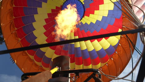 Colorful-Hot-Air-Balloons,-Burner-With-Flames-Heating-Up-Air-in-Parachute,-Low-Angle