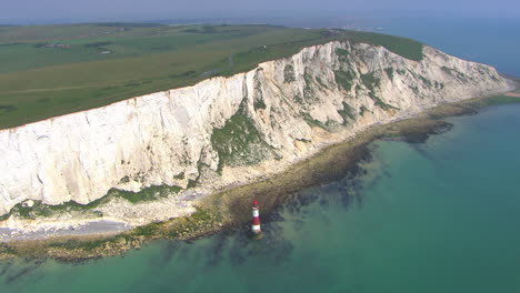 Aerial-rotating-shot-around-a-lighthouse-off-the-coast-of-the-White-Cliffs-of-Dover