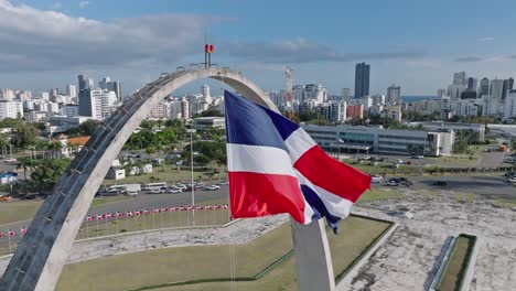 Dominican-Republic-Flag-Waving-Over-Triumphal-Arch-In-Plaza-De-La-Bandera,-Santo-Domingo