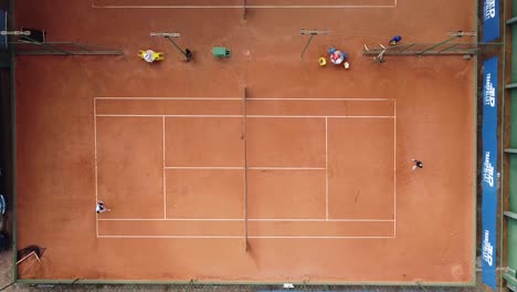 Birds-eye-drone-show-of-a-tennis-match-in-a-clay-court