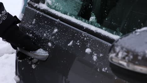 A-Person-With-Gloves-Is-Opening-The-Car-Door-With-Fresh-Snow