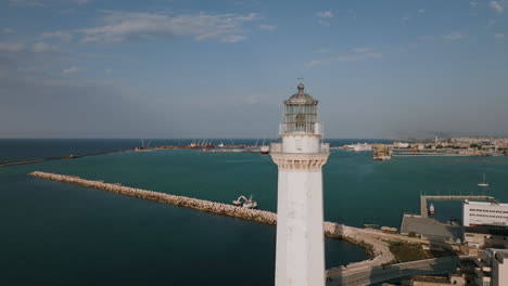 Aerial-footage-rotating-around-a-lighthouse-off-the-coast-of-Bari,-Italy-in-the-Adriatic-Sea