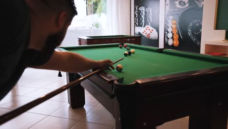 Billiard-casual-player-hitting-white-cue-ball-missing-the-shot